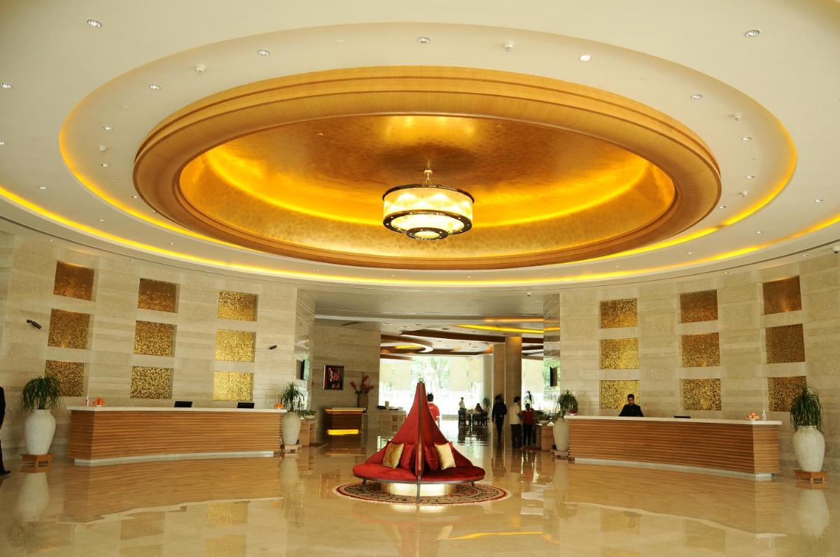 a lobby of a hotel with a large ceiling at The Lalit Chandigarh in Chandīgarh