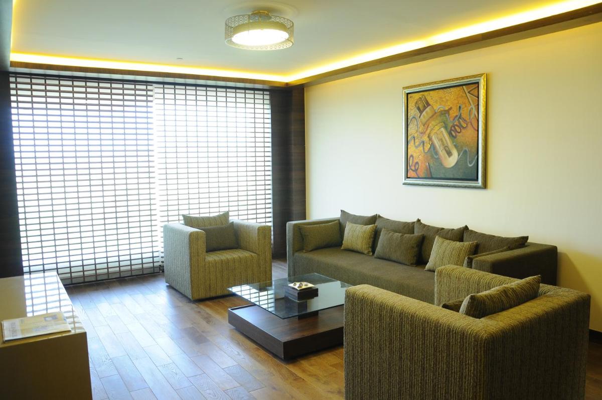 a living room with a couch and two chairs at The Lalit Chandigarh in Chandīgarh