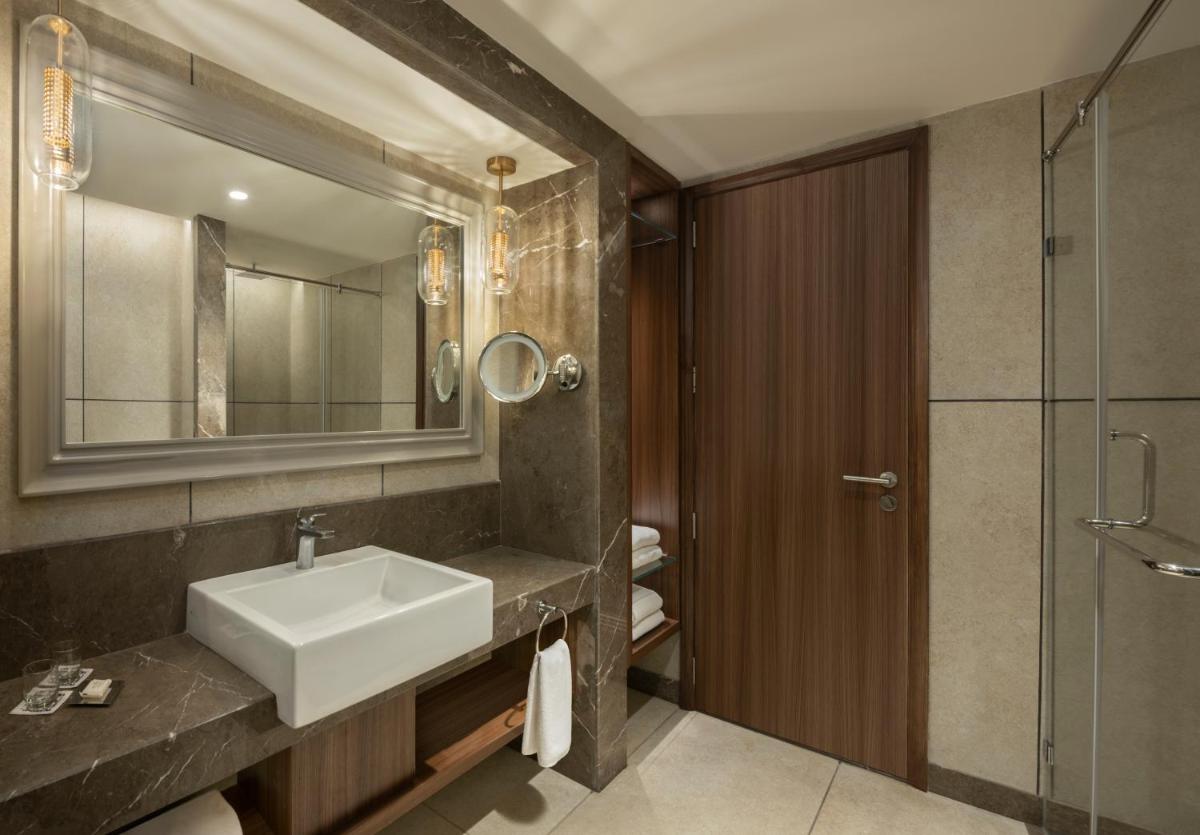 a bathroom with a sink and a shower at The Residency Towers Puducherry in Puducherry