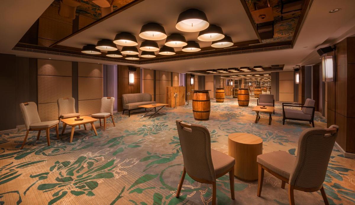 a rendering of a waiting room with tables and chairs at The Residency Towers Puducherry in Puducherry