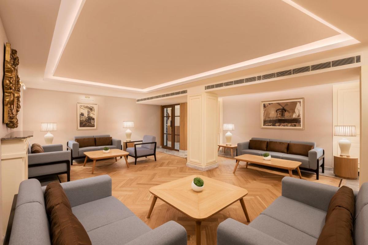 a living room with couches and tables at The Residency Towers Puducherry in Puducherry