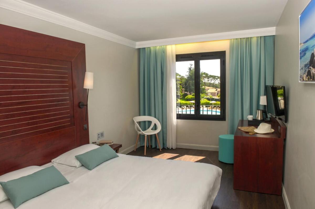 Un ou plusieurs lits dans un hébergement de l'établissement Hôtel Les Jardins De Sainte-Maxime