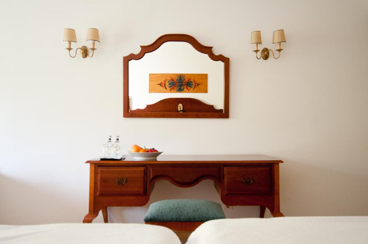 Uma cama ou camas num quarto em Quintinha Sao Joao Hotel & Spa