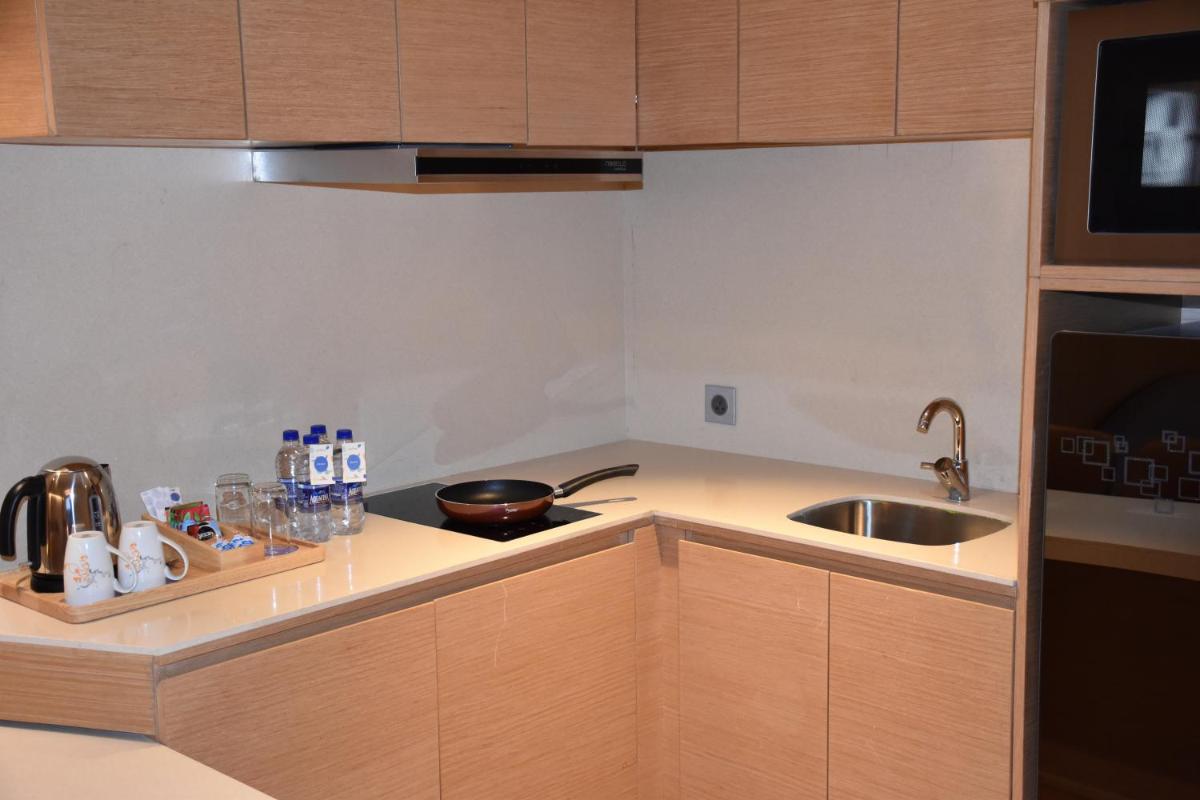 a kitchen with a sink and a counter top at Novotel Vijayawada Varun in Vijayawāda