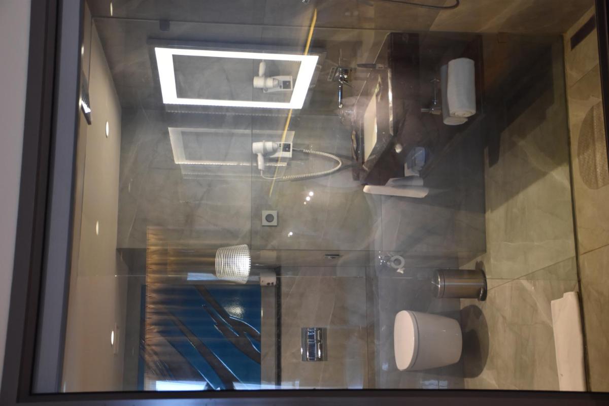 a view of a bathroom through a glass window at Novotel Vijayawada Varun in Vijayawāda