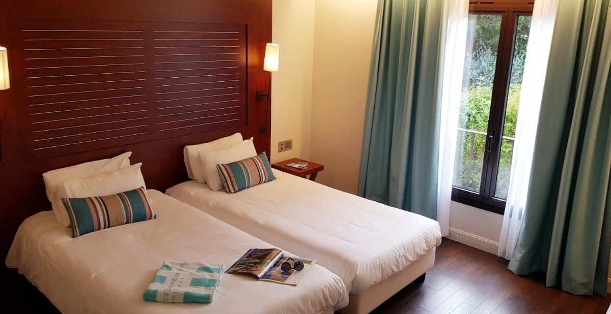Un ou plusieurs lits dans un hébergement de l'établissement Hôtel Les Jardins De Sainte-Maxime