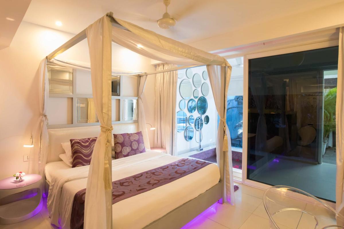 a bedroom with a bed with a canopy at The Park Calangute Goa in Calangute a bedroom with a bed with a canopy at The Park Calangute Goa in Calangute