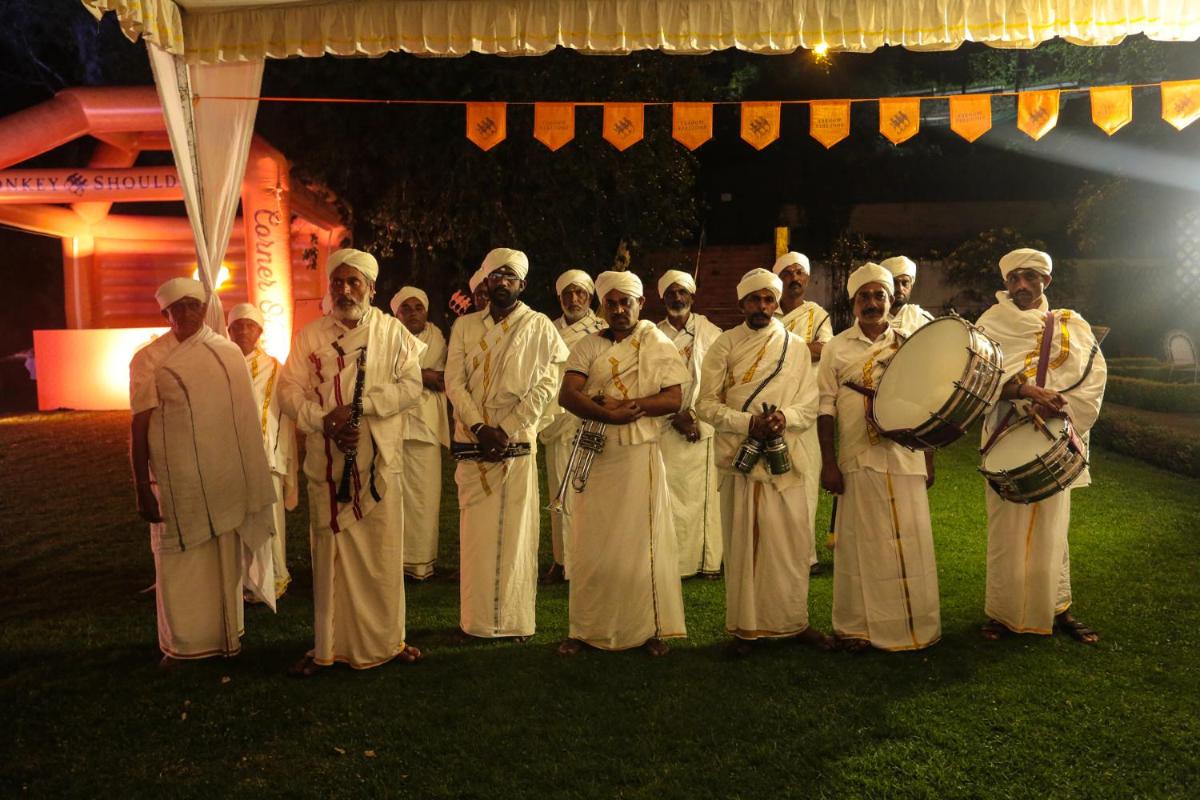 a group of men dressed in white posing for a picture at Savoy - IHCL SeleQtions in Ooty