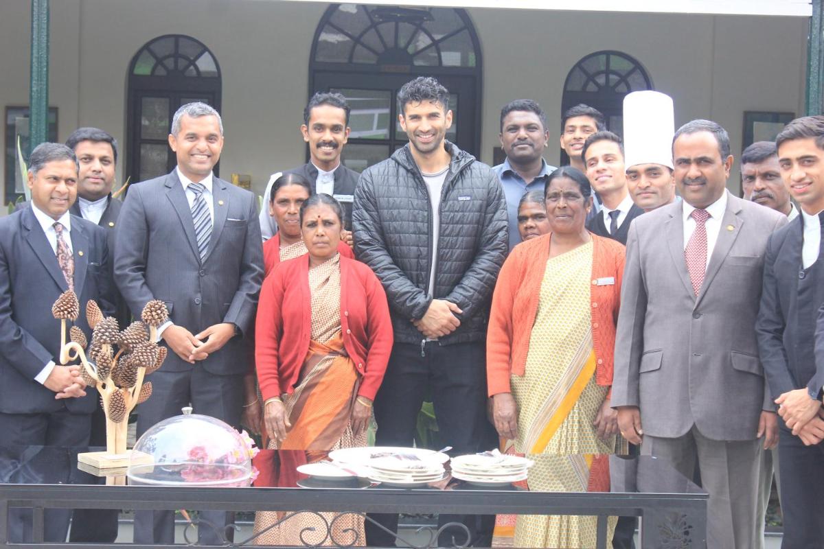 a group of people standing in front of a table at Savoy - IHCL SeleQtions in Ooty