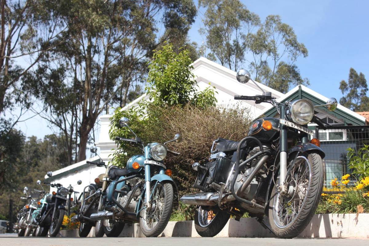 a row of motorcycles parked in front of a house at Savoy - IHCL SeleQtions in Ooty