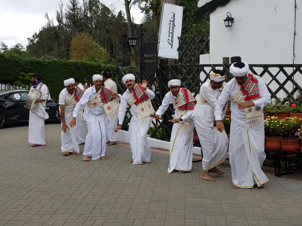 a group of men dressed in white are dancing at Savoy - IHCL SeleQtions in Ooty