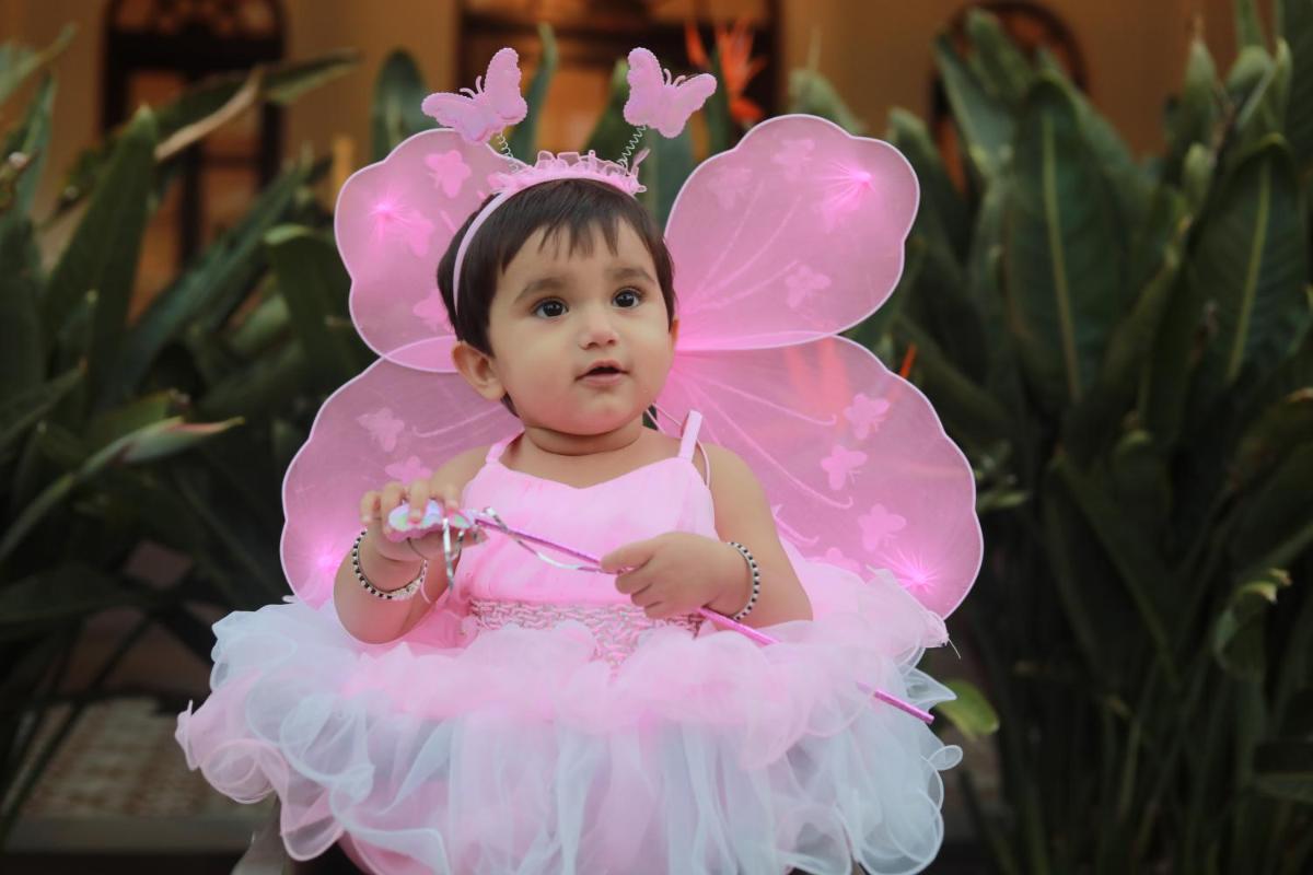 a baby dressed up in a pink fairy costume at Savoy - IHCL SeleQtions in Ooty