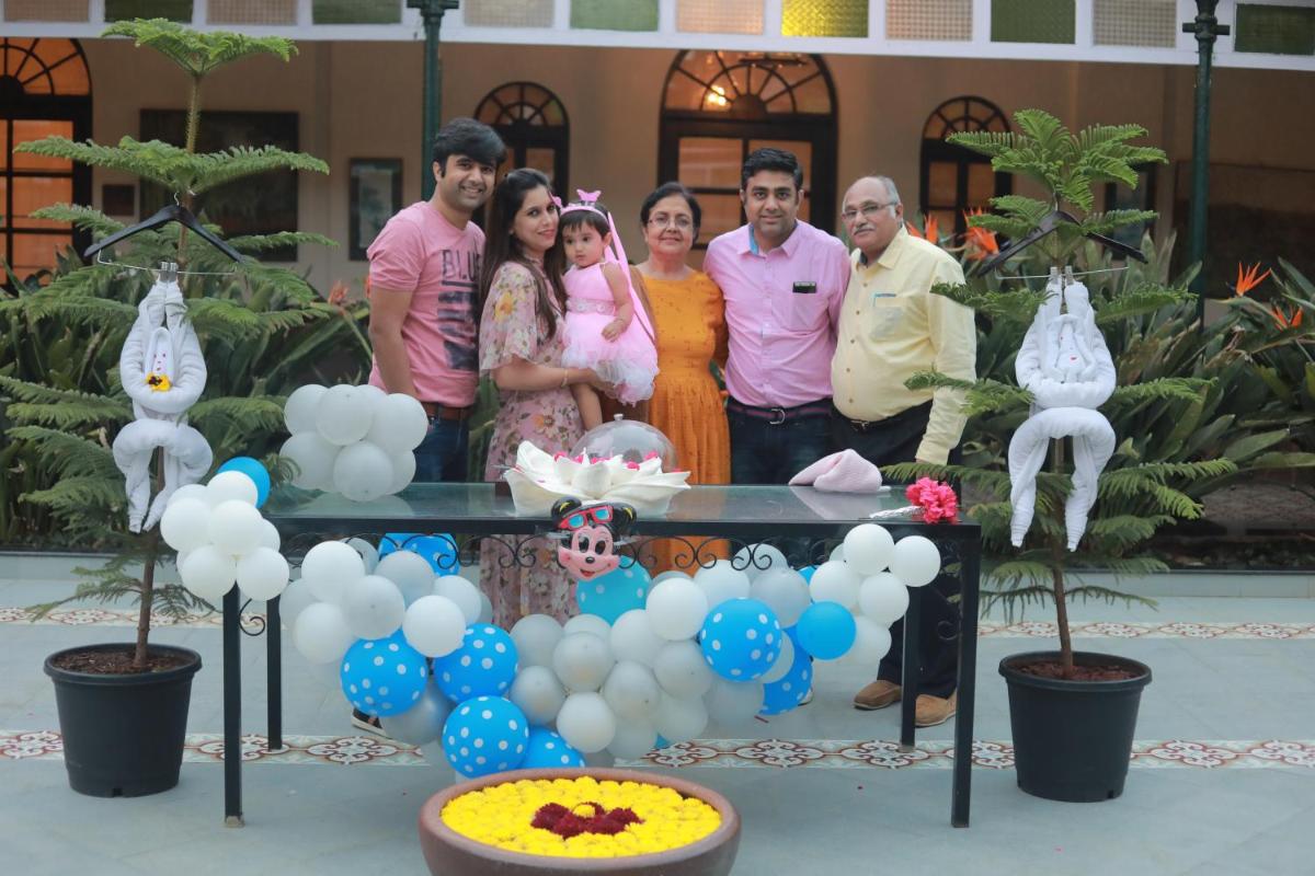 a group of people standing next to a table with balloons at Savoy - IHCL SeleQtions in Ooty