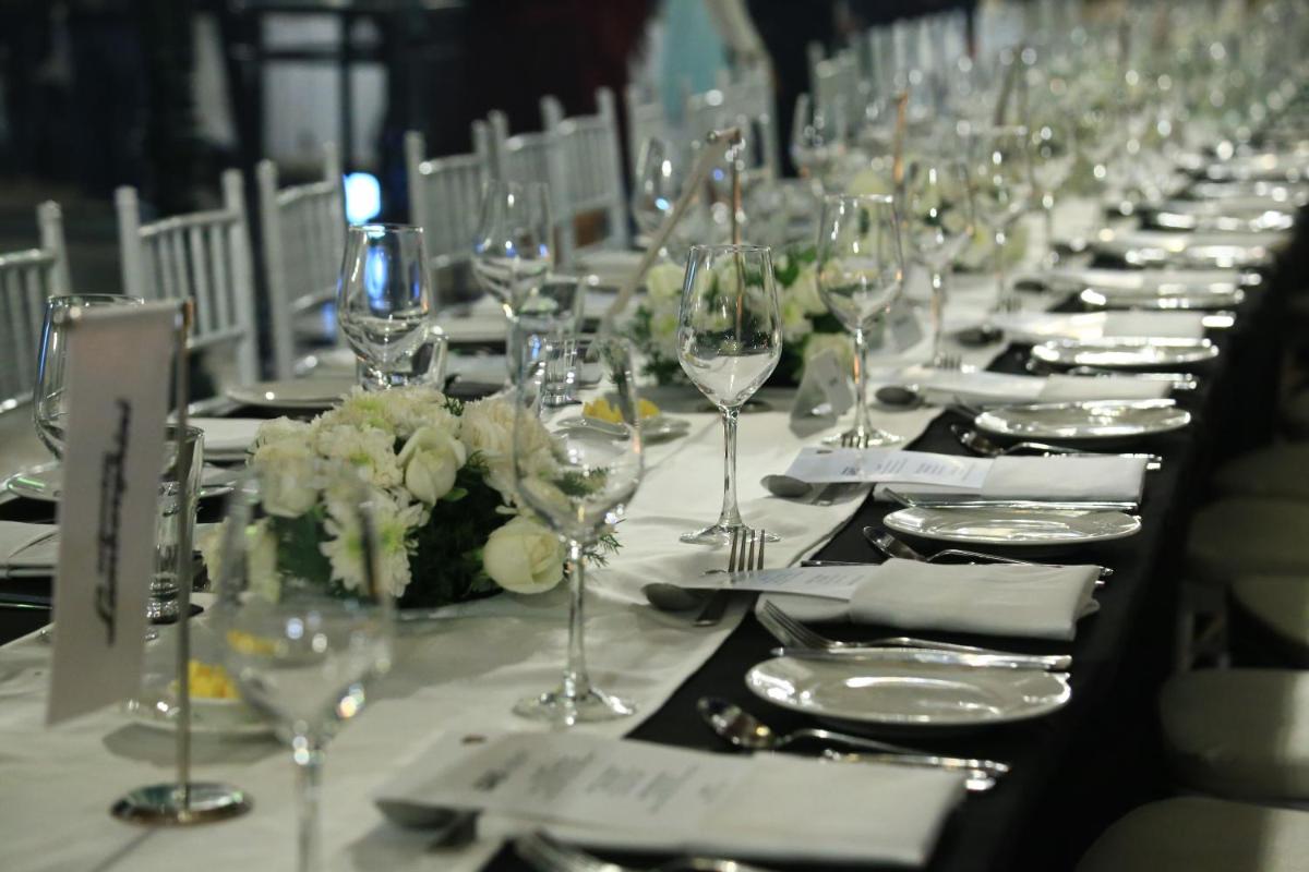 a long table with wine glasses and napkins at Savoy - IHCL SeleQtions in Ooty