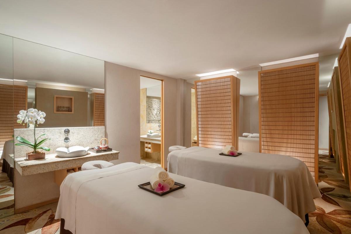 a hotel room with two beds and a bathroom at Shangri-La Rasa Sentosa, Singapore in Singapore