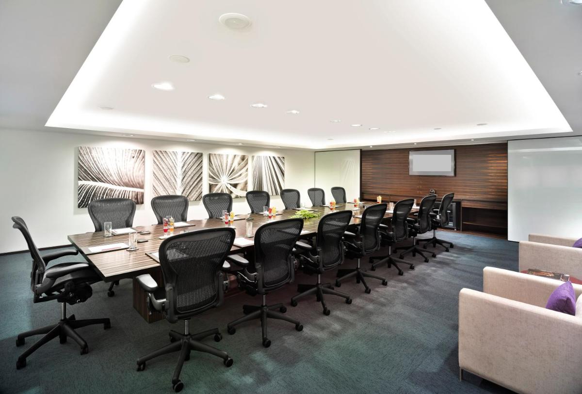 a conference room with a long table and chairs at Vivanta Chennai IT Expressway OMR in Chennai