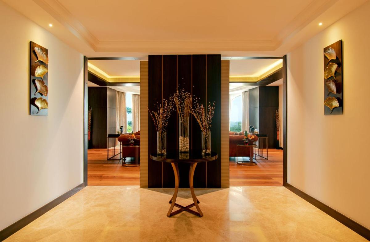 a hallway with a door with a plant in it at Radisson Blu Plaza Hotel Mysore in Mysore