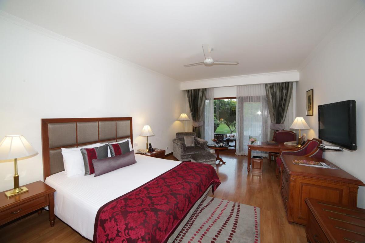 a hotel room with a bed and a television at Jaypee Palace Hotel in Agra