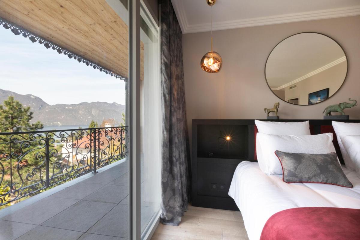 Un ou plusieurs lits dans un hébergement de l'établissement Hôtel L'Incomparable Aix-Les-Bains