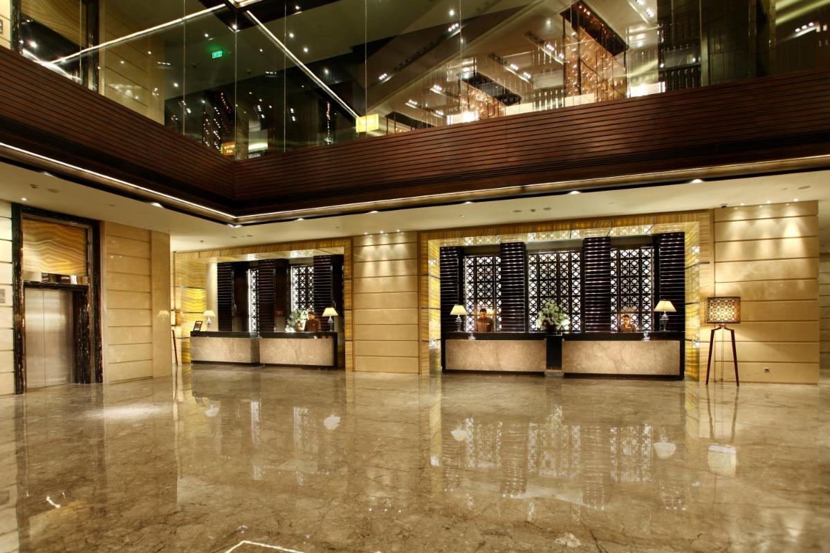 a lobby of a building with a marble floor at Crowne Plaza New Delhi Rohini by IHG in New Delhi a lobby of a building with a marble floor at Crowne Plaza New Delhi Rohini by IHG in New Delhi