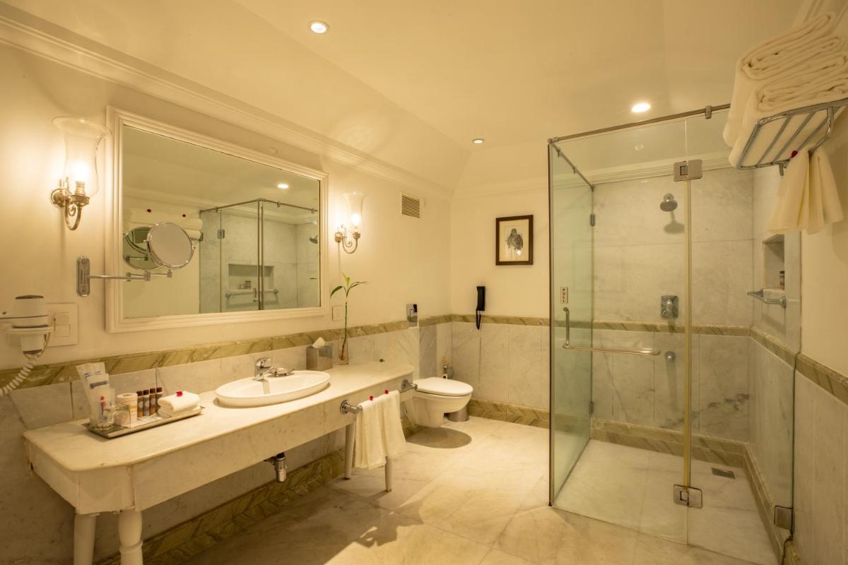 a bathroom with a sink and a shower and a toilet at Savoy - IHCL SeleQtions in Ooty