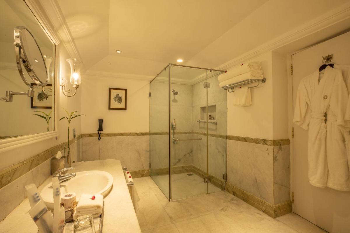 a bathroom with a shower and a sink and a shower at Savoy - IHCL SeleQtions in Ooty