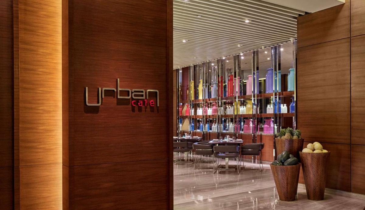 a restaurant with a liquor shelf with bottles of wine at Hyatt Regency Chandigarh in Chandīgarh