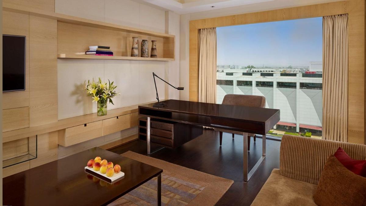 a living room with a desk and a piano at Hyatt Regency Chandigarh in Chandīgarh