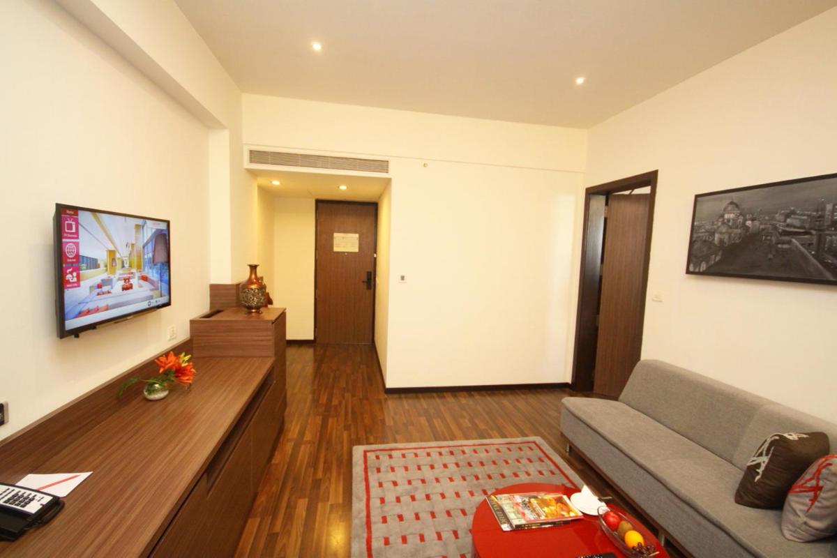 a living room with a couch and a tv at Vivanta Kolkata EM Bypass in Kolkata