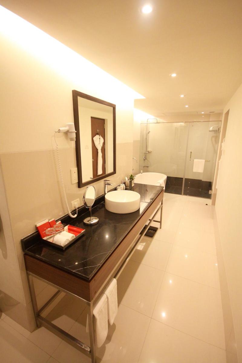 a bathroom with a sink and a toilet in a room at Vivanta Kolkata EM Bypass in Kolkata