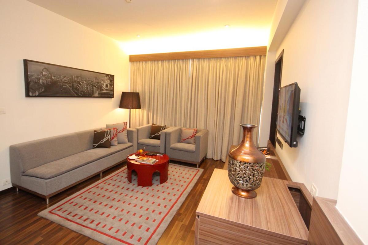 a living room with a couch and a table at Vivanta Kolkata EM Bypass in Kolkata