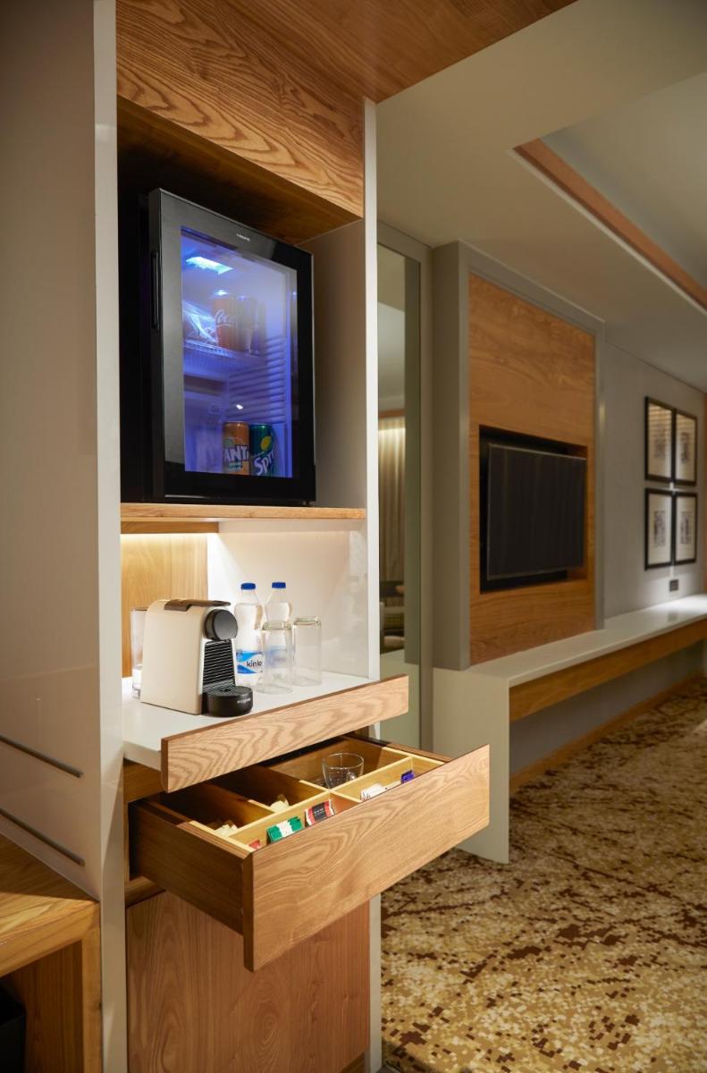 a room with a entertainment center with a tv at The Residency Towers Puducherry in Puducherry