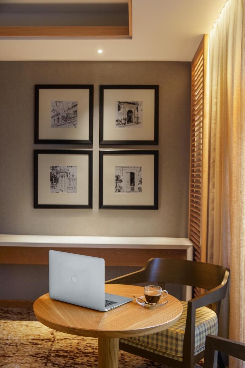 a laptop sitting on a table in a room at The Residency Towers Puducherry in Puducherry