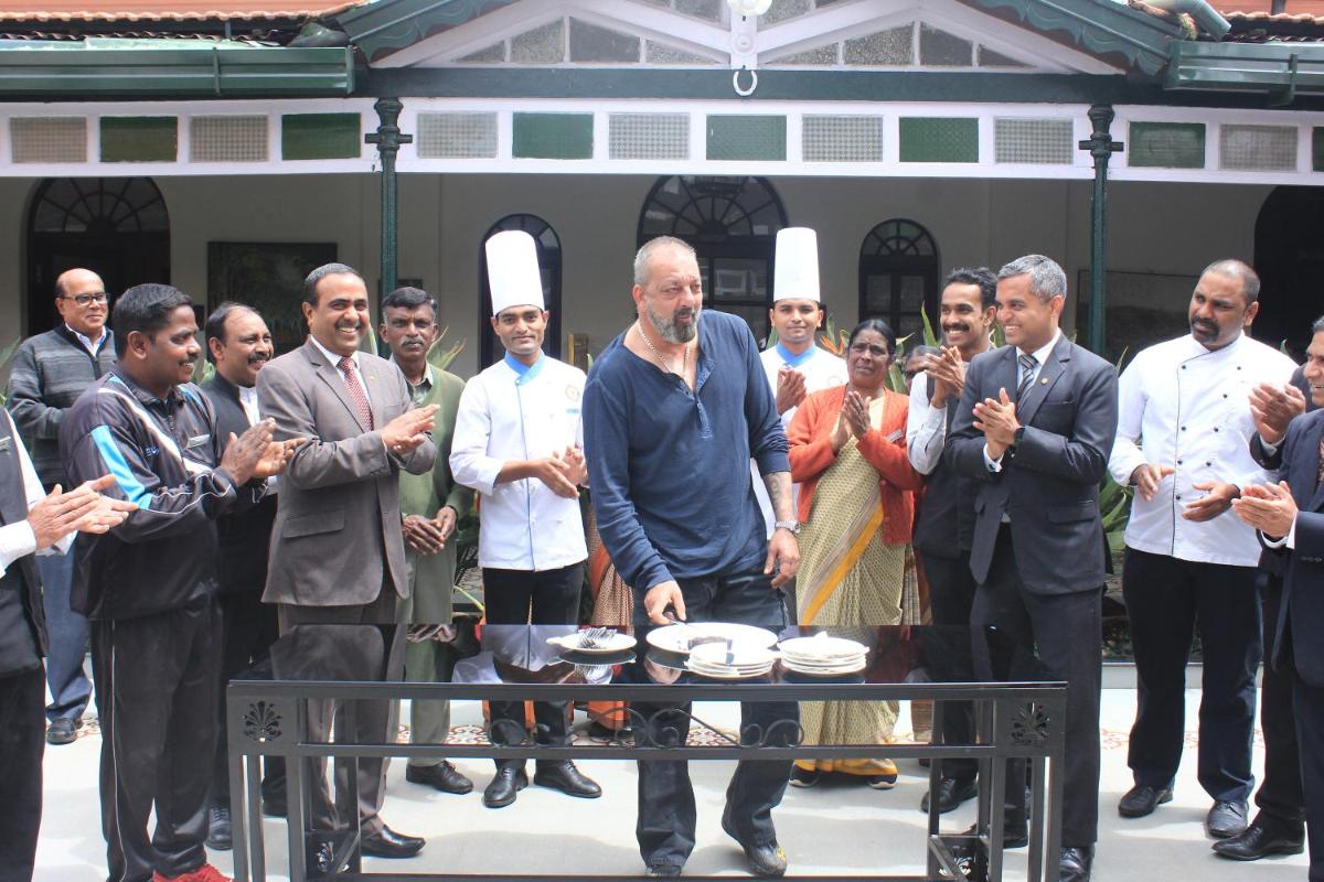 a man standing in front of a group of people at Savoy - IHCL SeleQtions in Ooty