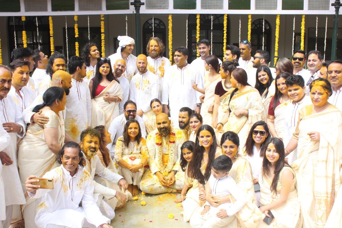 a group of people in white posing for a picture at Savoy - IHCL SeleQtions in Ooty