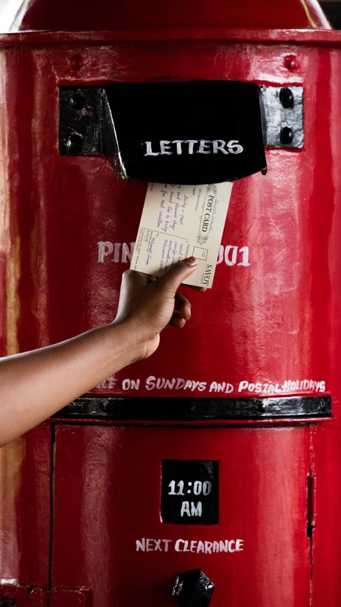 a person holding a piece of paper on a red object at Savoy - IHCL SeleQtions in Ooty