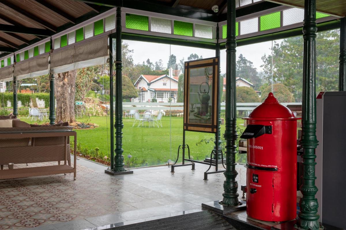 a red fire hydrant sitting inside of a building at Savoy - IHCL SeleQtions in Ooty