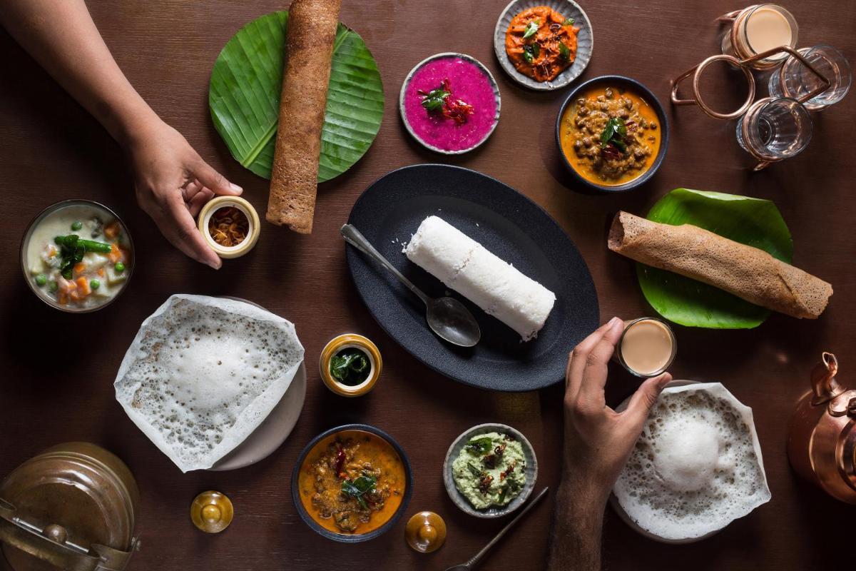 a table topped with lots of different types of food at Grand Hyatt Kochi Bolgatty in Cochin