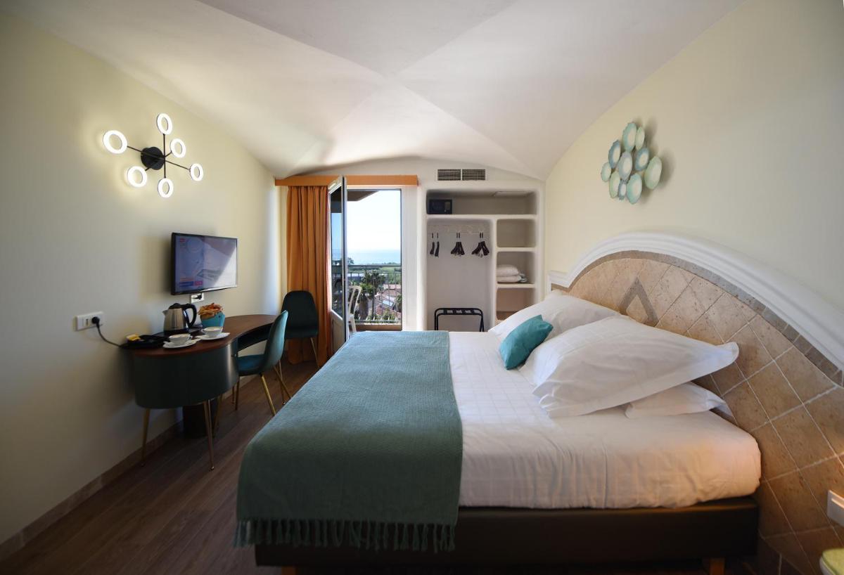Un ou plusieurs lits dans un hébergement de l'établissement Ostella Spa & Resort