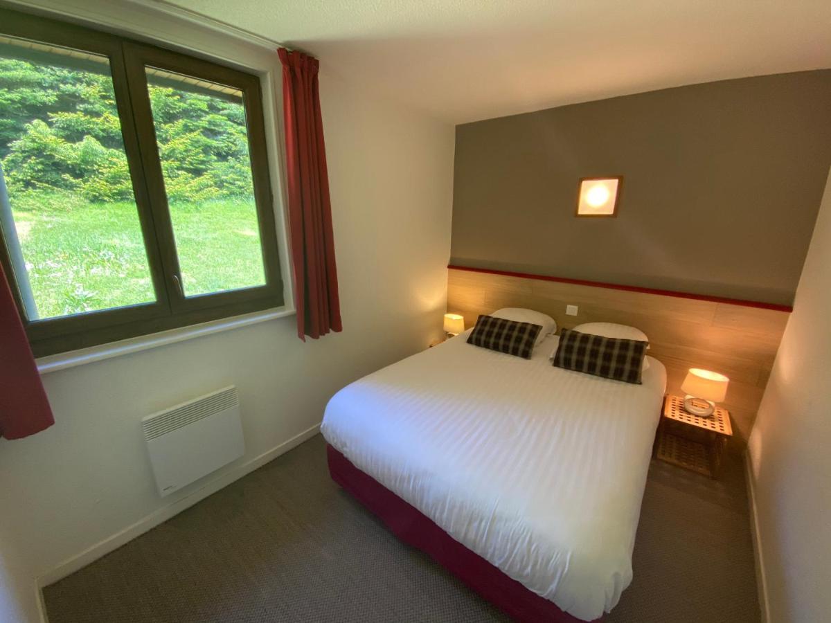 Un ou plusieurs lits dans un hébergement de l'établissement Sancy Resort