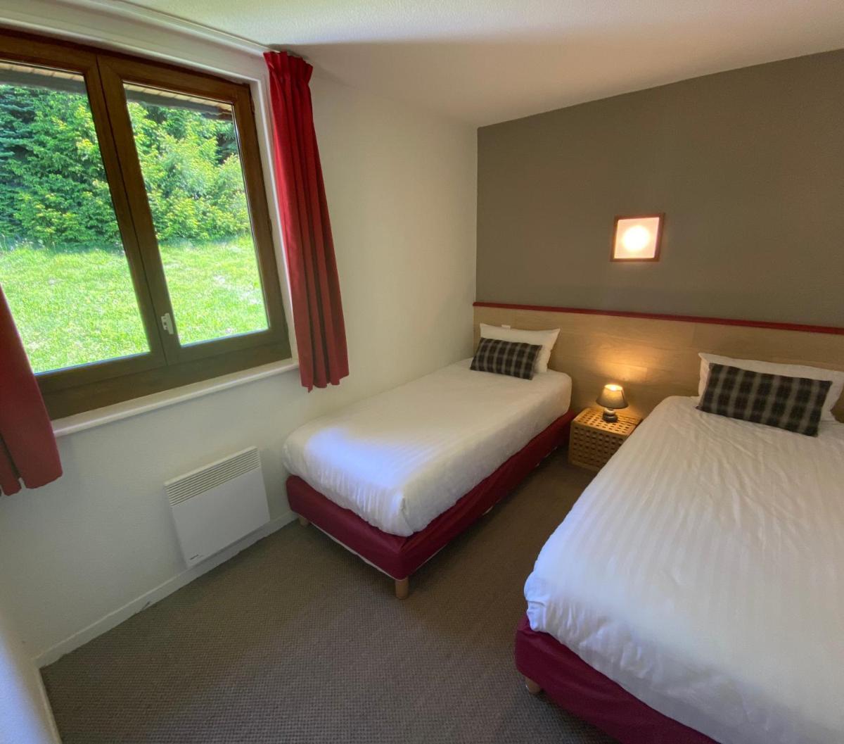 Un ou plusieurs lits dans un hébergement de l'établissement Sancy Resort