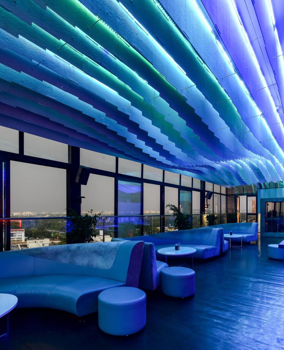 a large building with blue seating and windows at Crowne Plaza Pune City Centre by IHG in Pune