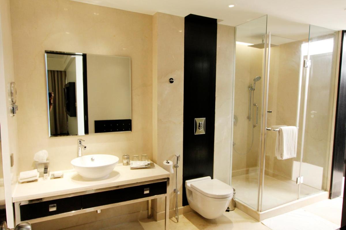a bathroom with a sink and a toilet and a shower at Crowne Plaza Pune City Centre by IHG in Pune