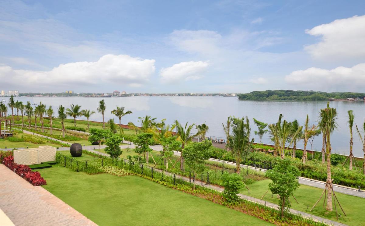 a view of a large body of water with palm trees at Grand Hyatt Kochi Bolgatty in Cochin