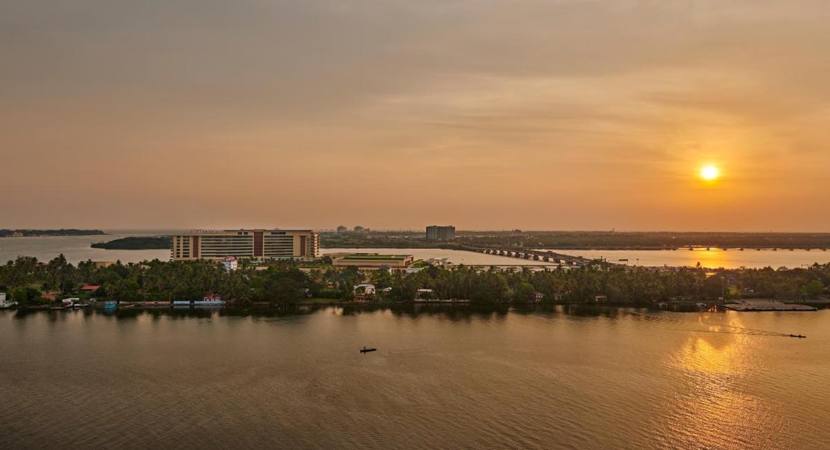 a view of a river with the sunset in the background at Grand Hyatt Kochi Bolgatty in Cochin