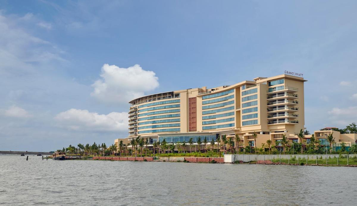 a large building next to a body of water at Grand Hyatt Kochi Bolgatty in Cochin