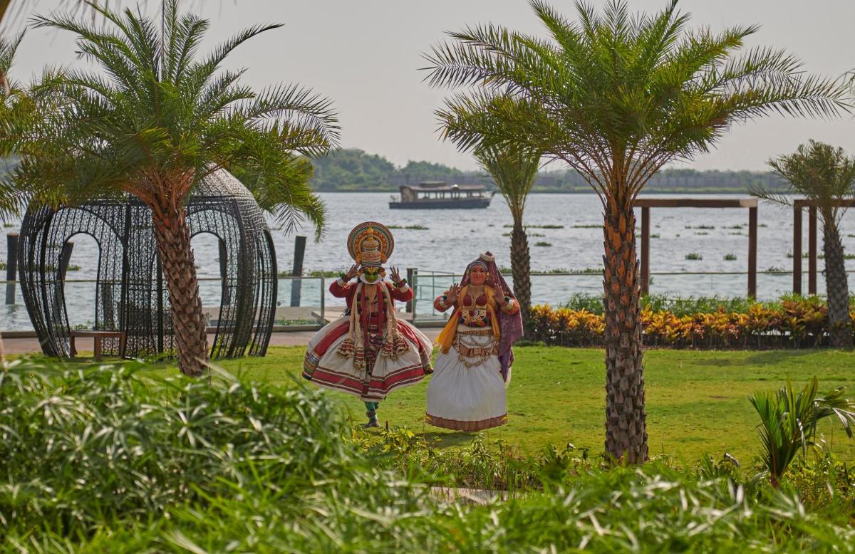 two statues of two women standing next to a body of water at Grand Hyatt Kochi Bolgatty in Cochin