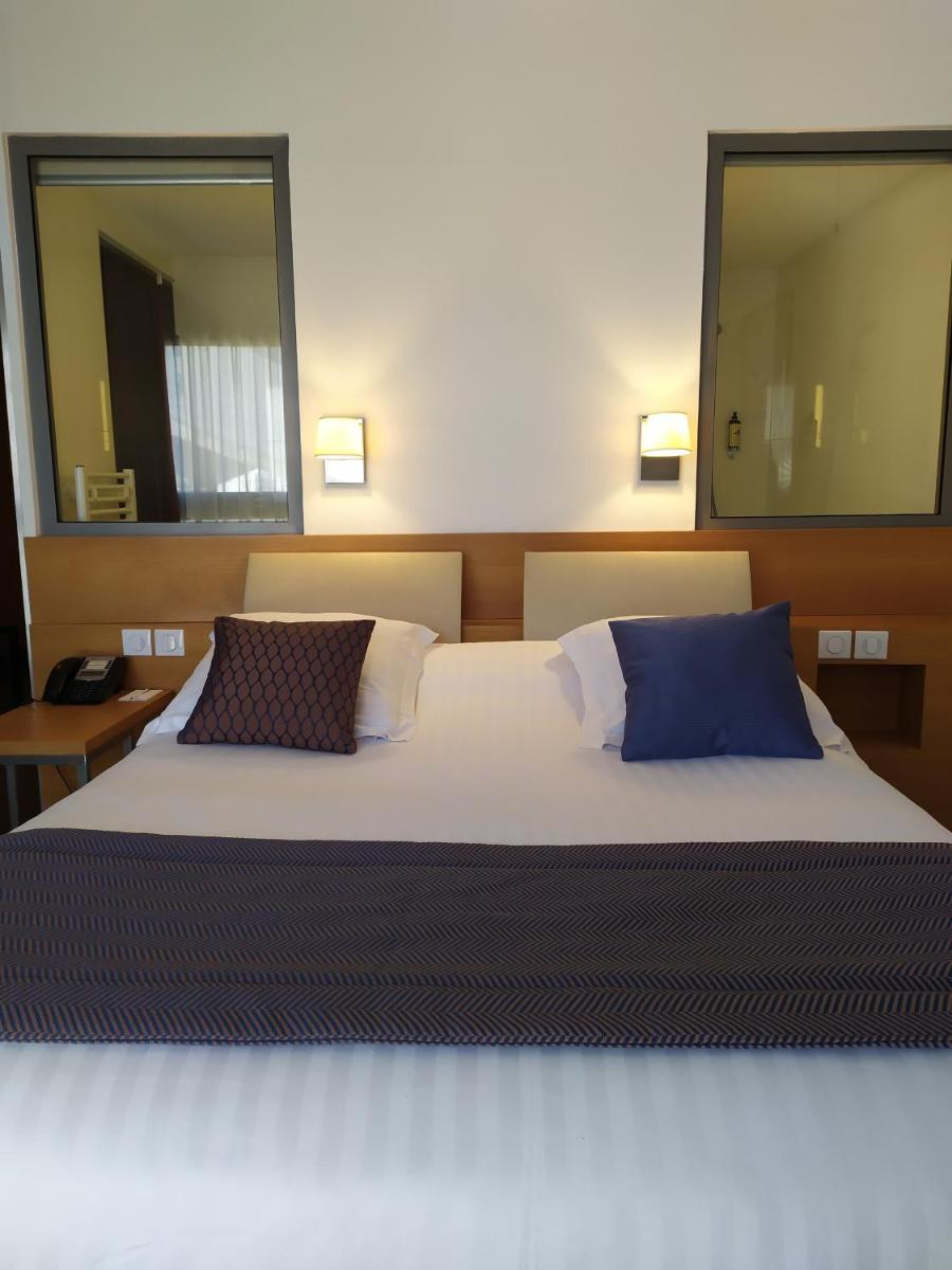 Un ou plusieurs lits dans un hébergement de l'établissement Best Western Premier Hôtel du Vieux-Port