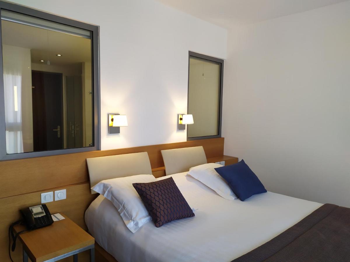 Un ou plusieurs lits dans un hébergement de l'établissement Best Western Premier Hôtel du Vieux-Port