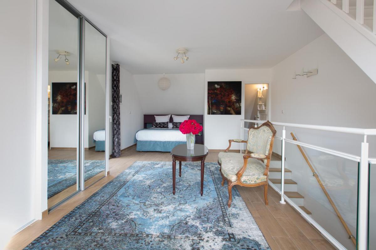 Coin salon dans l'établissement Hôtel Le Cep & Spa